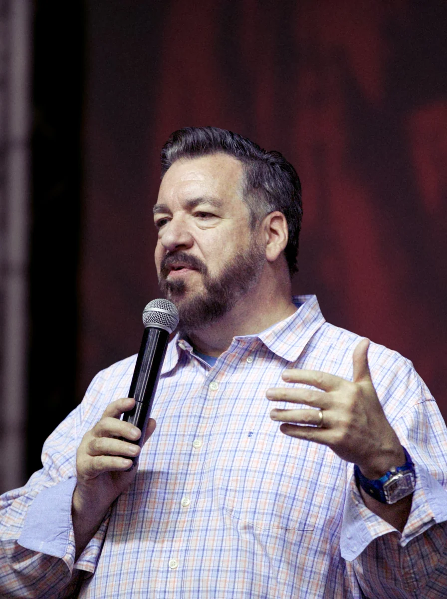 Lon Dean preaching with a microphone.